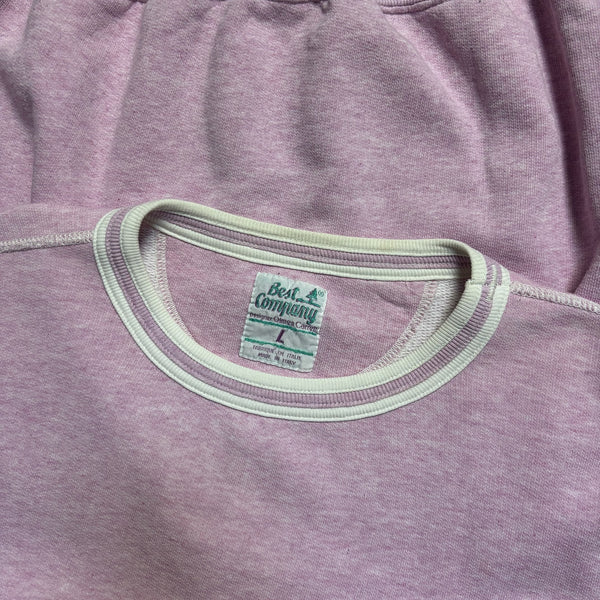 Close-up of a purple sweatshirt with a visible brand label.